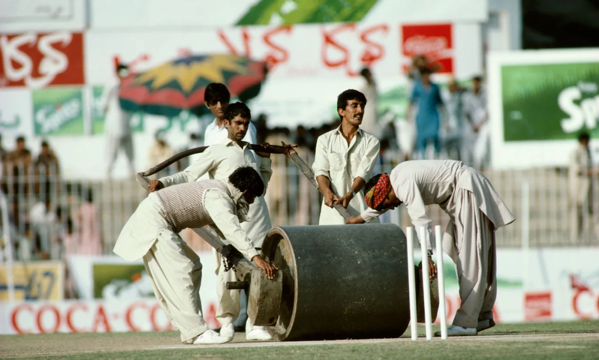 Ground staff use the heavy roller on the pitch